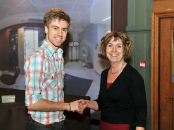 Oliver Angell being presented with his prize by Dr. Julia Shelton