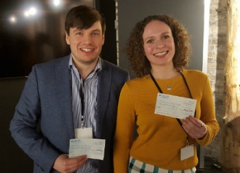 Richard and Kseniya holding their 1st and 2nd prizes, respectively