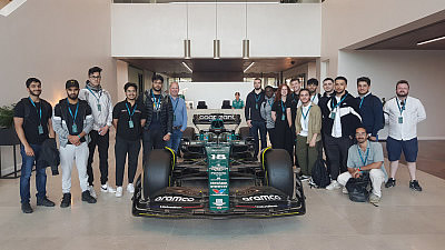 Students and staff with last year's Aston Martin F1 car